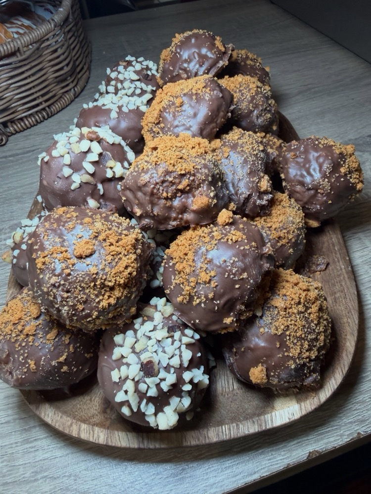 Chocolate truffle bites topped with nuts and biscuit crumb