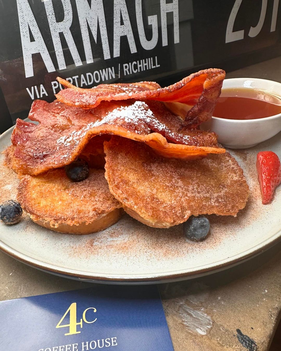 French toast with streaky bacon, cinnamon sugar, berries and maple syrup