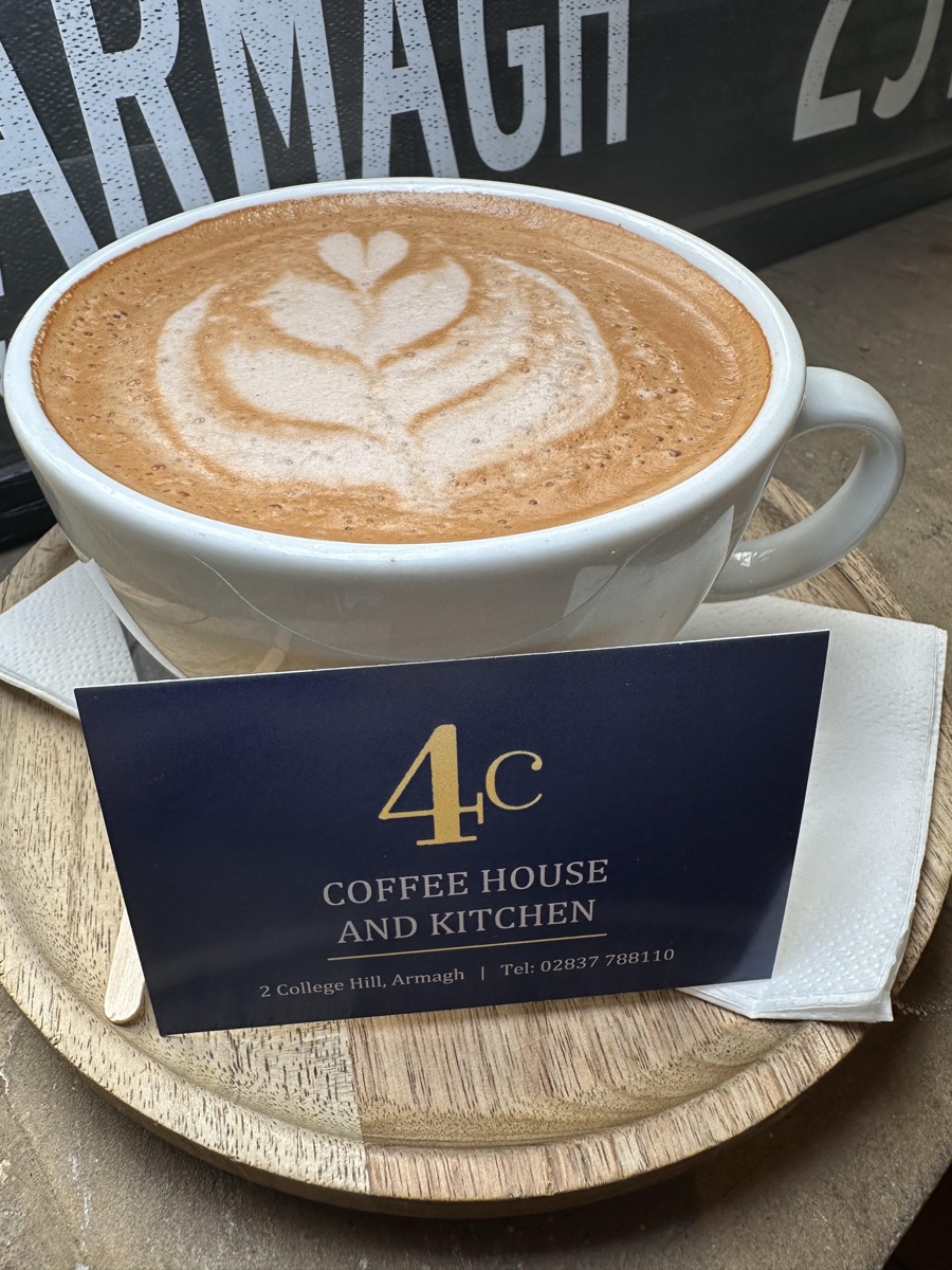 A mocha with latte art on a wooden board
