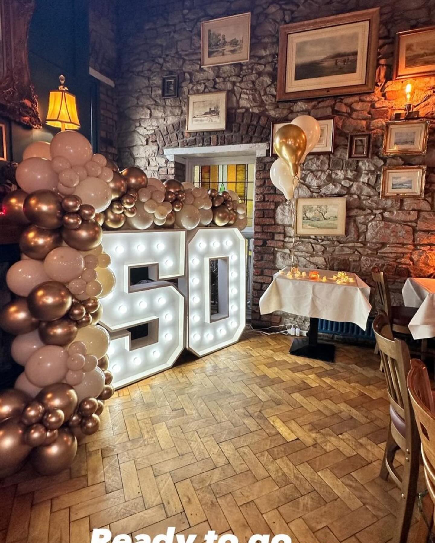 The stone-walled upstairs room at 4C, decorated for a private birthday celebration
